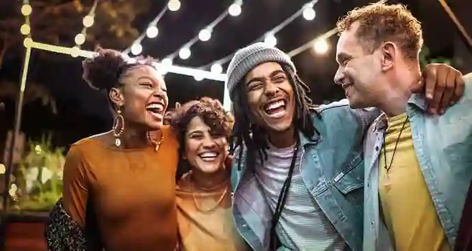 Four friends side by side laughing