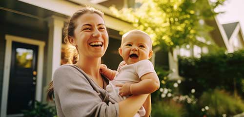 Mom holding baby and laughing