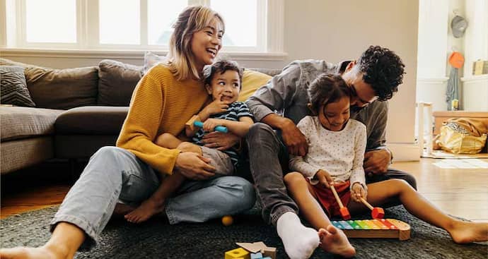 Mom and dad playing with kids in living room