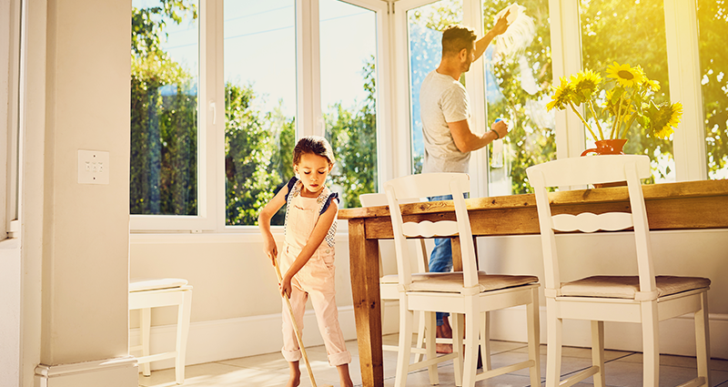 Father and daughter sping cleaning in kithcen