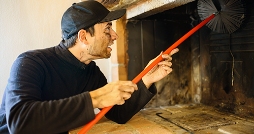 Man cleaning fireplace cimney
