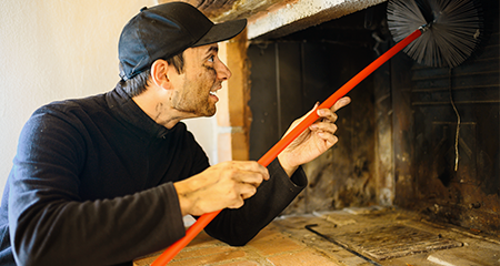 Man cleaning fireplace cimney