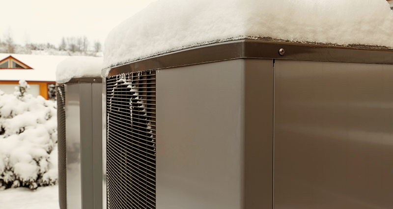 Heat pump covered in snow