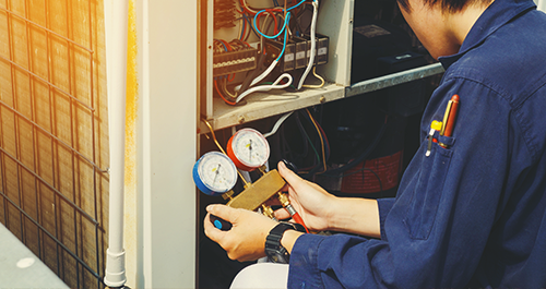 Contractor checking furnace pressure levels