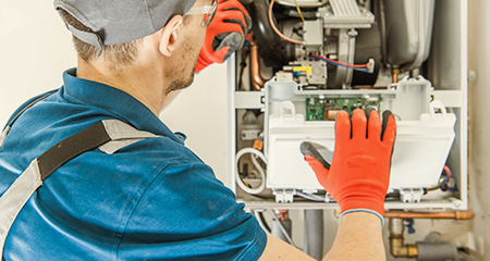 Professional technician looking at furnace componenets