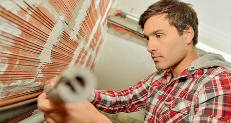 Man inspecting pipes and plumbing for winter