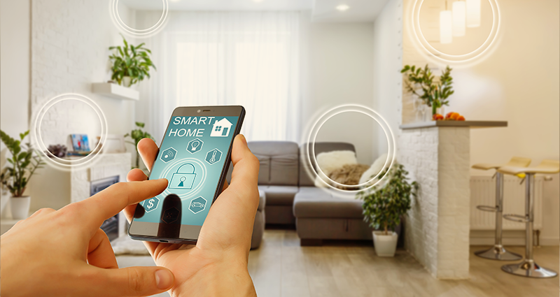 Person with mobile phone displaying home security