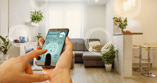 Person with mobile phone displaying home security