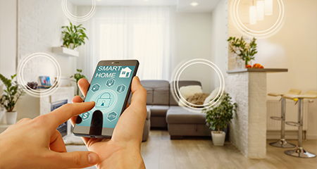 Person with mobile phone displaying home security