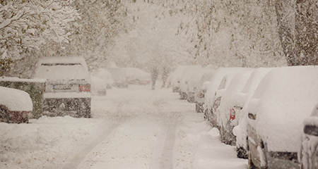 Image of street lined snow-covered cars
