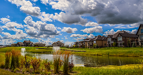 Image of residential community with pond in middle