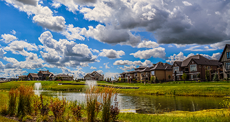 Image of residential community with pond in middle