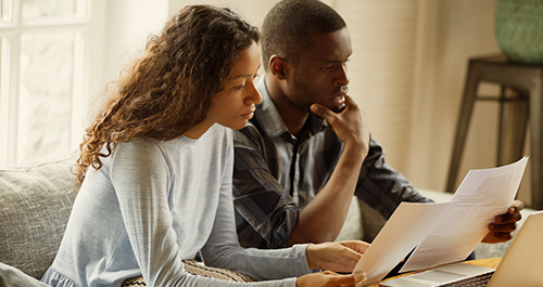 Couple reviewing Alberta electricity rates on their bill