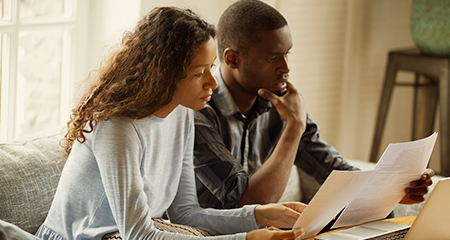 Couple reviewing Alberta electricity rates on their bill