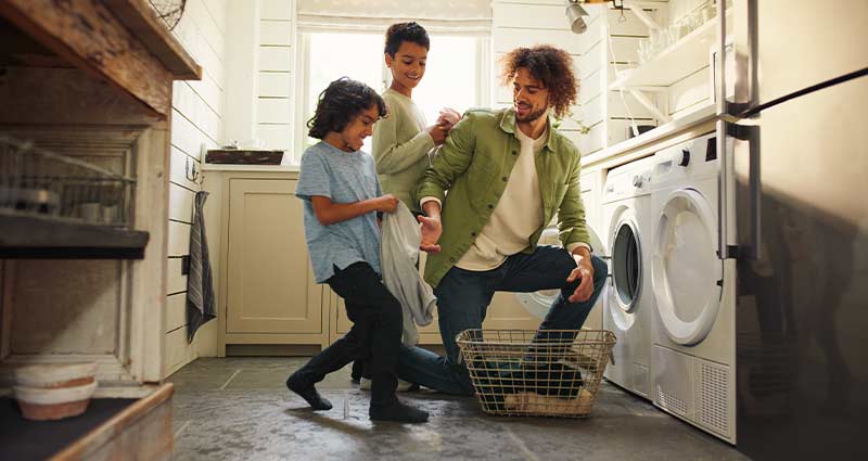 Dad doing laundry with the kids