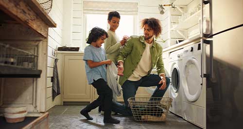 Dad doing laundry with the kids