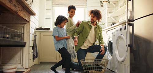 Dad doing laundry with the kids